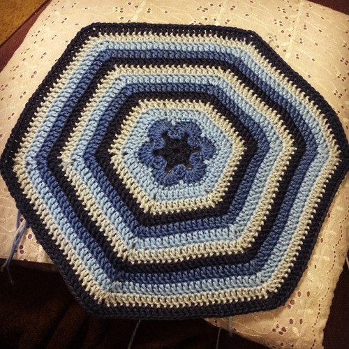 Blue crocheted african flower hexagon, made with Cascade Yarns